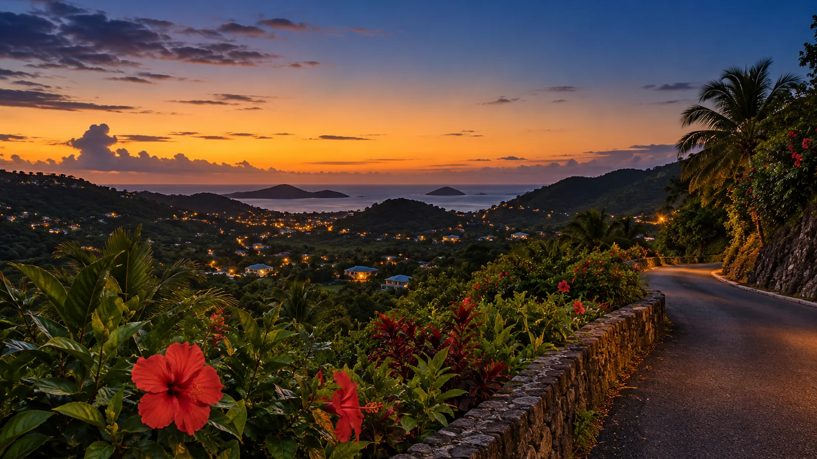 A hill road at dusk with hibiscus flowers and warm house lights in the valley